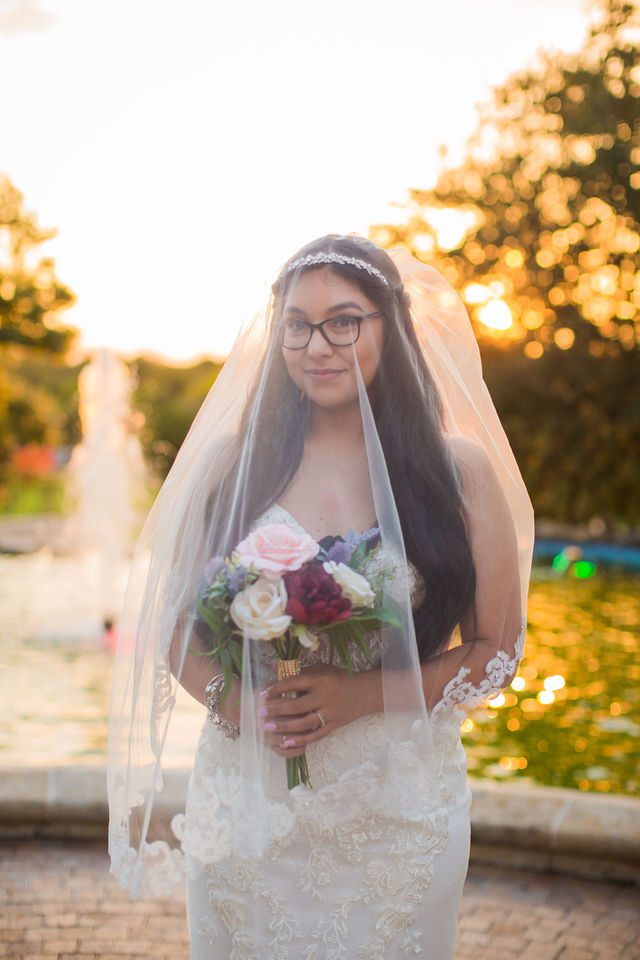 Bethany's bridal portrait at the McNay fountain at sunset under veil