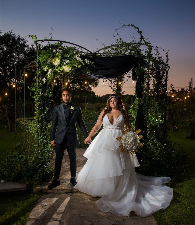 Mayra and Jaytee's portrait in the gazebo at sunset at Oak Valley Vineyards