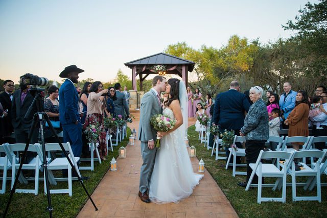 Margaret's wedding at the Club of Garden Ridge ceremony exit kiss