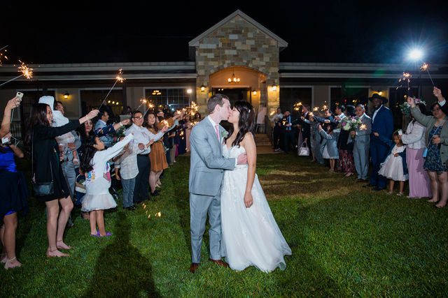 Margaret's wedding at the Club of Garden Ridge reception sparkler exit kiss