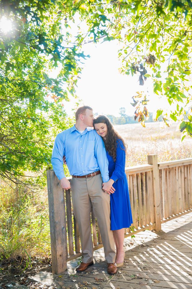 Coltan and Stephanie engagement on the bridge at Cibolo Natural Area head kiss
