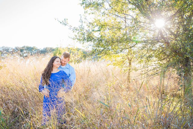 Coltan and Stephanie's engagement in the tall grass at Cibolo Natural Area head kiss