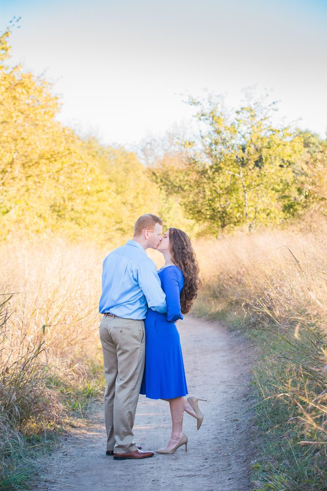 Coltan and Stephanie's the engagement at Cibolo Natural Area kissing on the path
