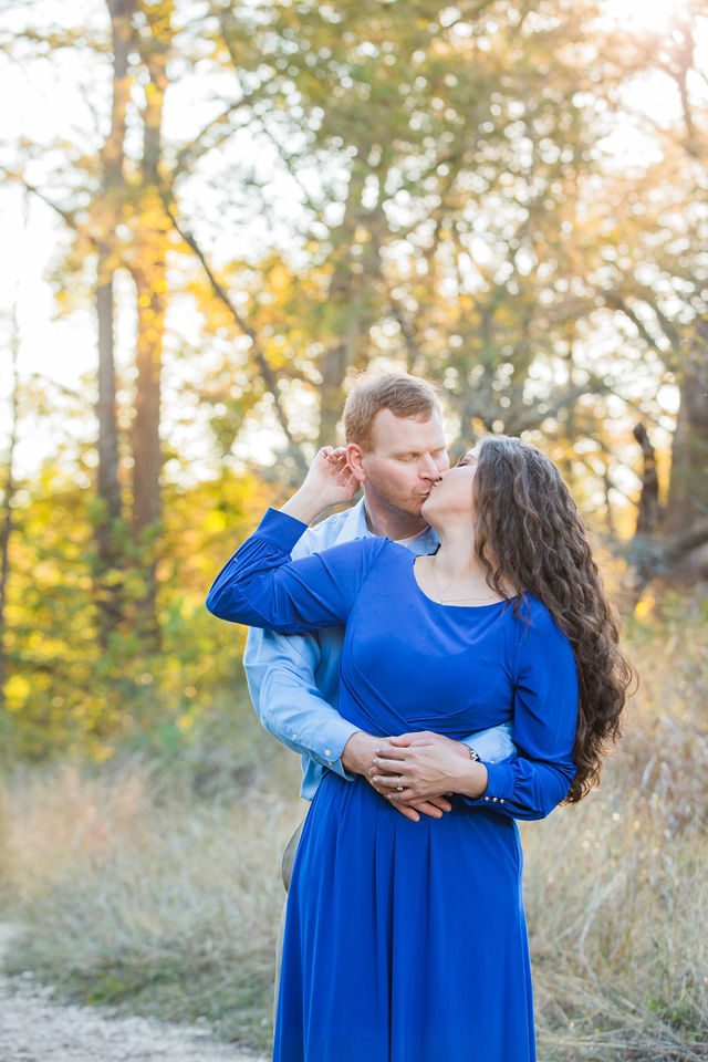 Coltan and Stephanie's the engagement at Cibolo Natural Area kissing in the sun