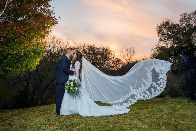 Stephanie & Coltan's wedding at the Kendall Inn in Boerne veil flying portrait
