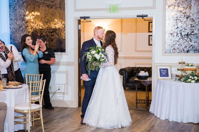 Stephanie's wedding reception at the Kendall Inn entrance kiss