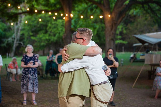Haley's Wedding at Elm Pass Woods reception toasts dad hug