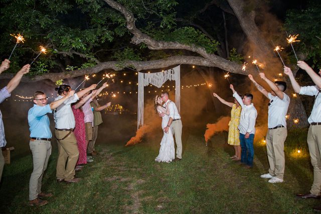 Haley's Wedding at Elm Pass Woods reception sparkler exit kiss