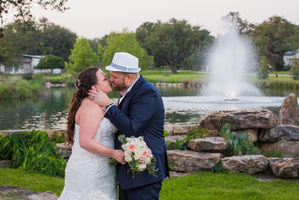 Jenny's wedding kiss at the fountain at the Club at Garden Ridge