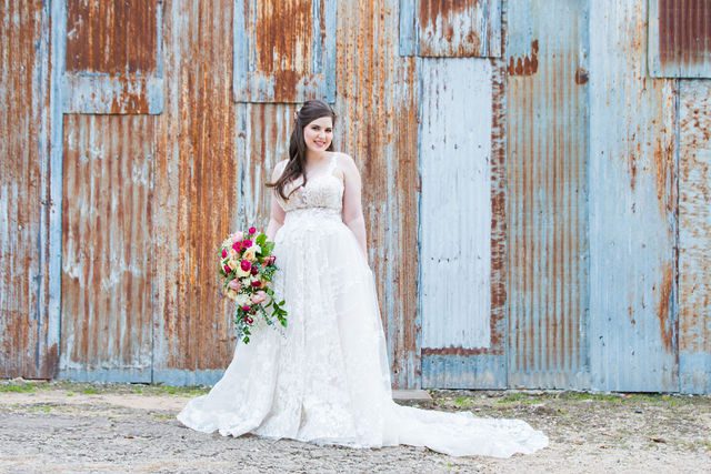 Meagan Bridal at the Gruene and New Braunfels tin wall with flowers