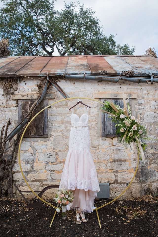 Yoli's dress on the arch at their wedding at Canyon Springs cottage area