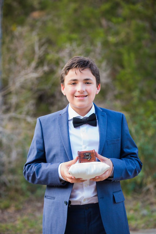 Yoli's son holding the rings at the wedding at Canyon Springs in San Antonio