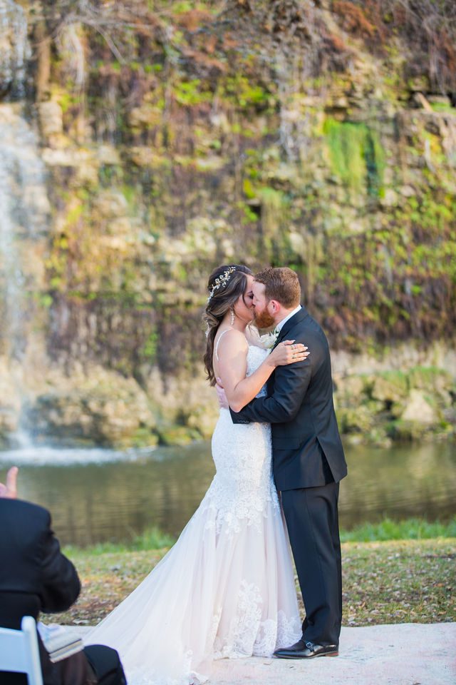Yoli and Daltin kiss at the wedding ceremony at Canyon Springs in San Antonio