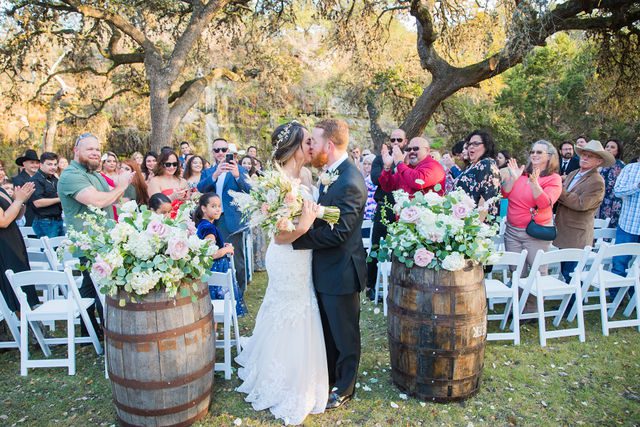 Yoli and Daltin aisle kiss at the wedding ceremony at Canyon Springs in San Antonio