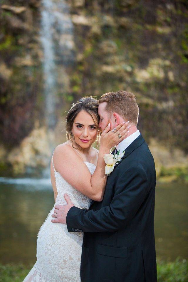 Yoli and Daltin hugging at the wedding at Canyon Springs waterfall