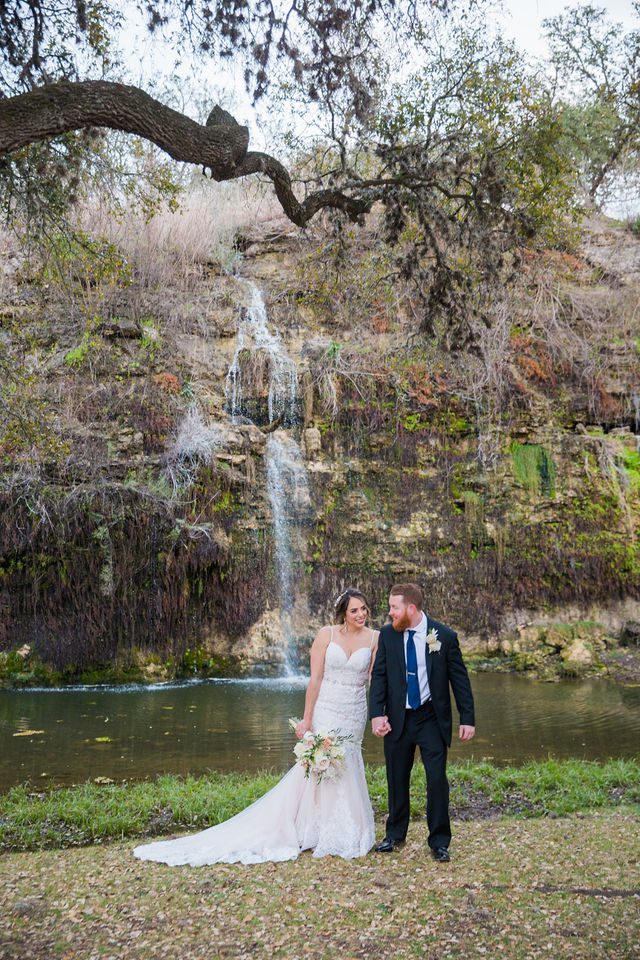 Yoli and Daltin walking at the wedding at Canyon Springs waterfall