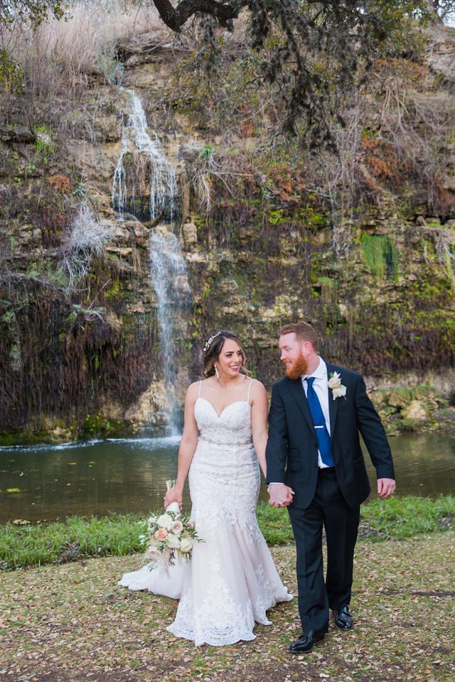 Yoli and Daltin walking at the waterfall at wedding at Canyon Springs