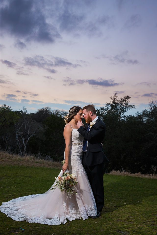 Yoli and Daltin sunset kiss on the hill at their wedding at Canyon Springs