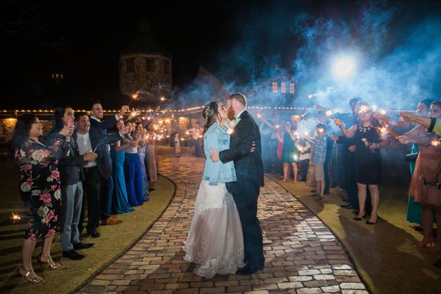 Yoli's and Daltin wedding reception sparkler exit kiss at Canyon Springs