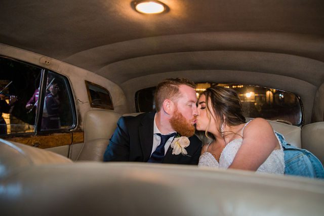 Yoli's and Daltin wedding reception limo kiss at Canyon Springs