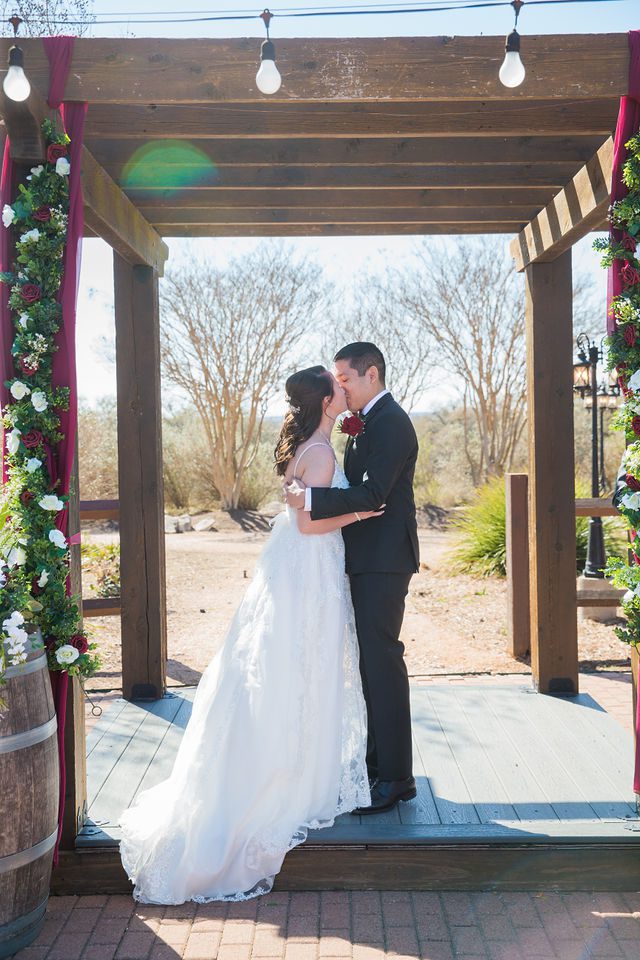 Allison wedding at Hofmann Ranch bride and groom's ceremony kiss