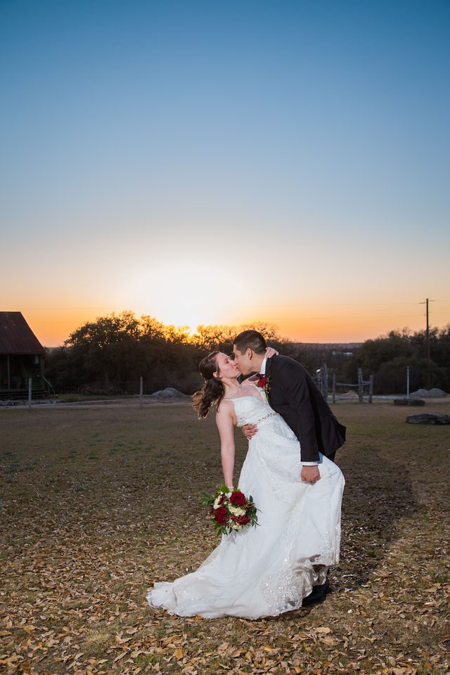 Allison's wedding at Hofmann Ranch sunset portrait kiss dip