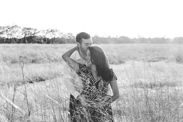 Bethany and Adam engagement Cibolo Natural Area black and whit in the grass