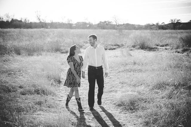 Bethany and Adam engagement Cibolo Natural Area walking in the grass