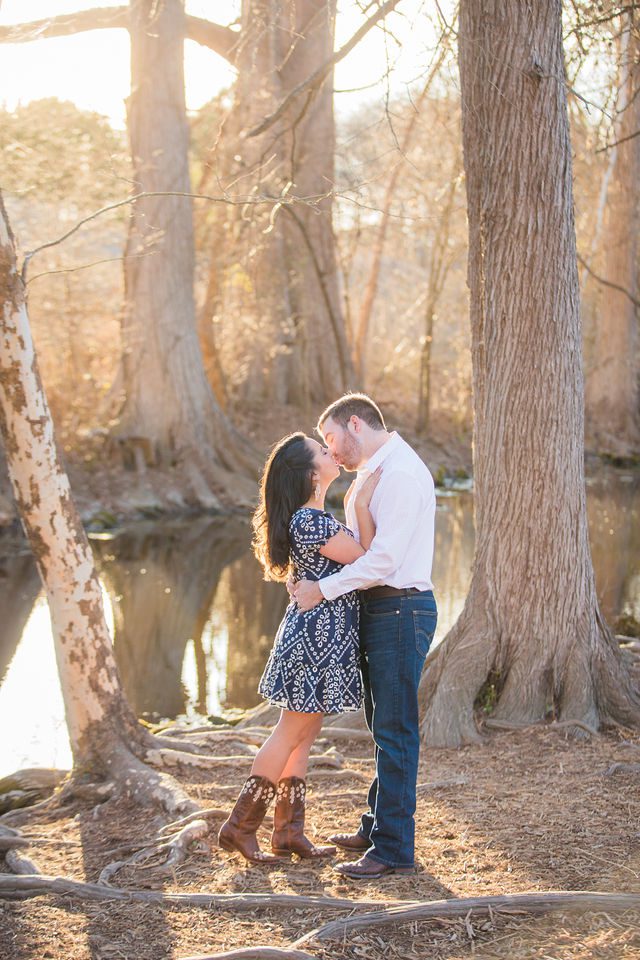 Bethany and Adam engagement Cibolo Natural Area kiss by the river golden light