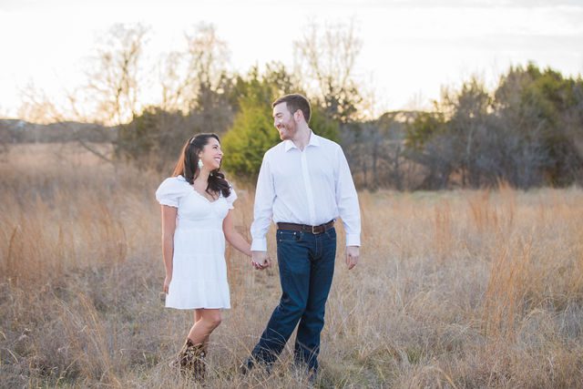 Bethany and Adam engagement walking in the grass Cibolo Natural Area