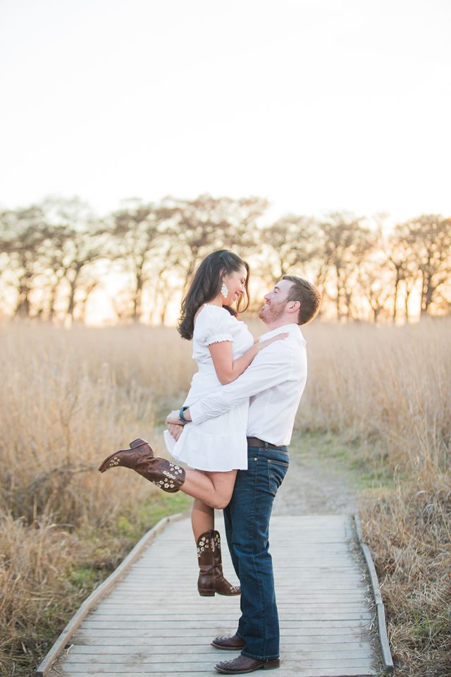 Bethany and Adam engagement lift on the bridge at Cibolo Natural Area
