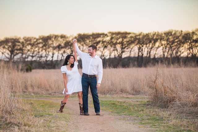 Bethany and Adam engagement at Cibolo Natural Area dancing on the path