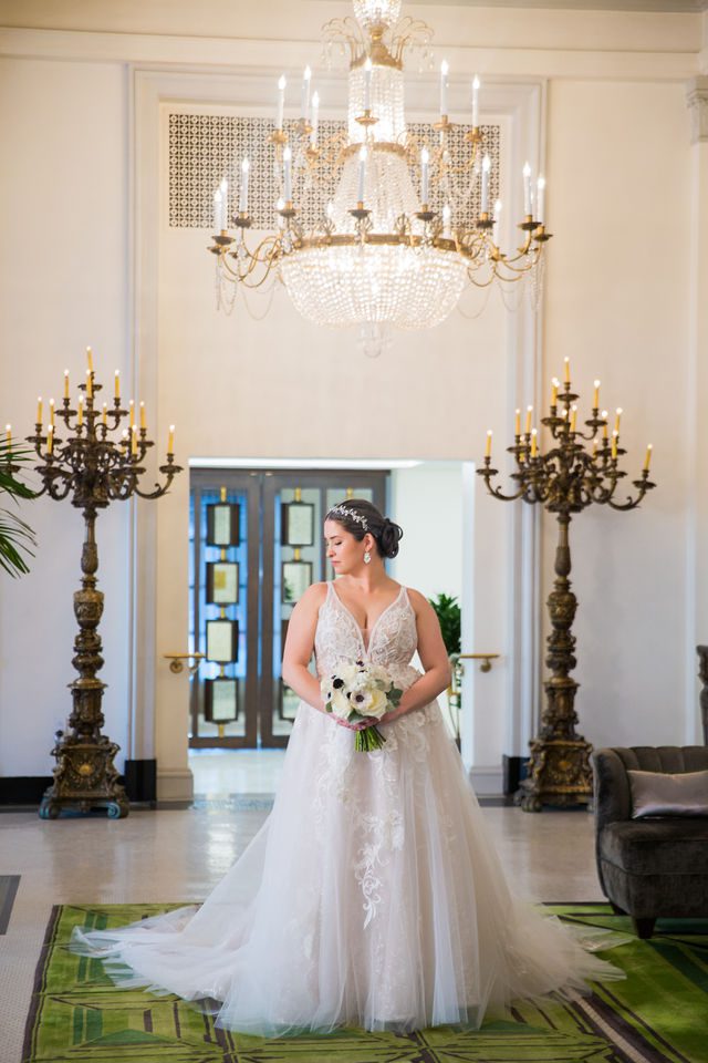 Bonnie's Bridal at the St Anthony Hotel bride in front of the chandelier