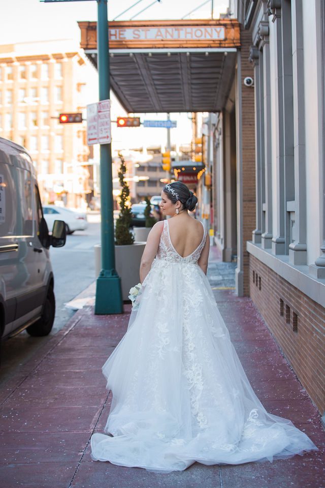 Bonnie's Bridal at the St Anthony Hotel bride on the sidewalk back
