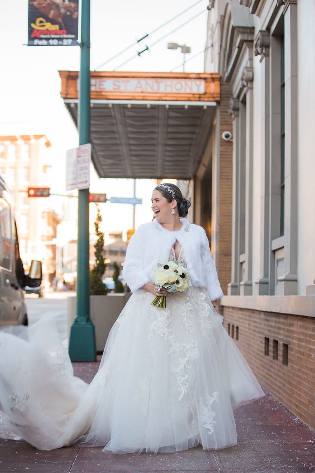 Bonnie's Bridal at the St Anthony Hotel bride on the sidewalk laughing