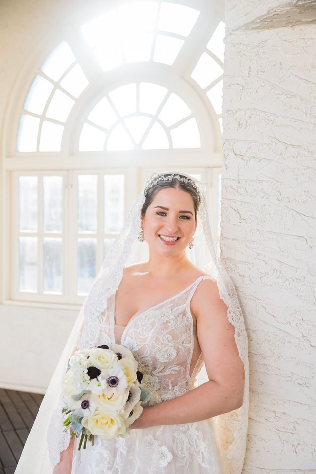 Bonnie's Bridal at the St Anthony Hotel on the rooftop with veil headshot in the window