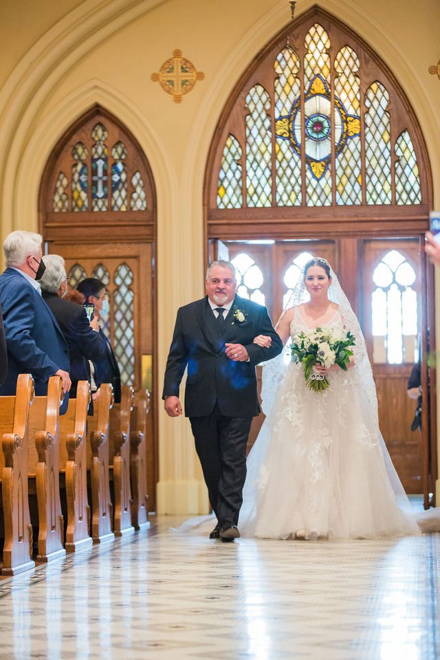Bonnie's wedding ceremony at OLLU Sacred Heart Chapel bride on aisle