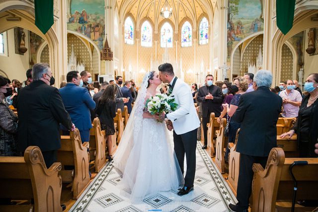 Bonnie's wedding ceremony at OLLU Sacred Heart Chapel kiss