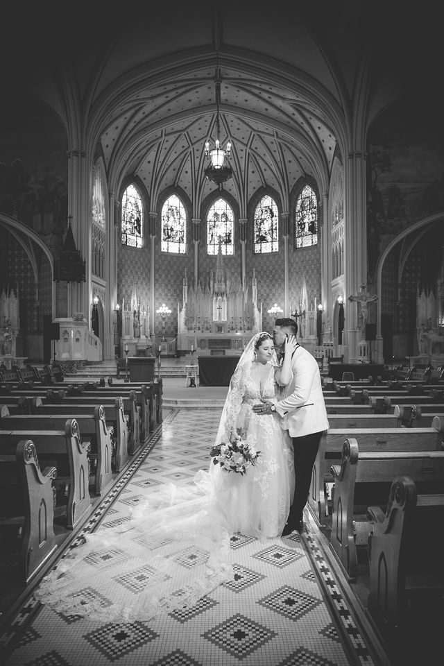 Bonnie's wedding portrait on the aisle side kiss at OLLU Sacred Heart Chapel