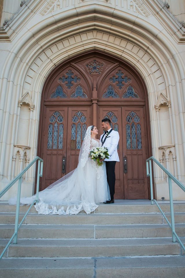 Bonnie's wedding portrait on the steps at OLLU Sacred Heart Chapel