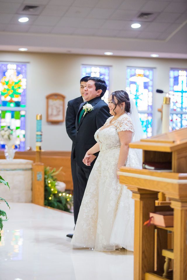 Chloe's San Antonio wedding ceremony at St. Dominic's Catholic Church bride laughing