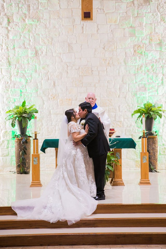 Chloe's San Antonio wedding ceremony kiss at St. Dominic's Catholic
