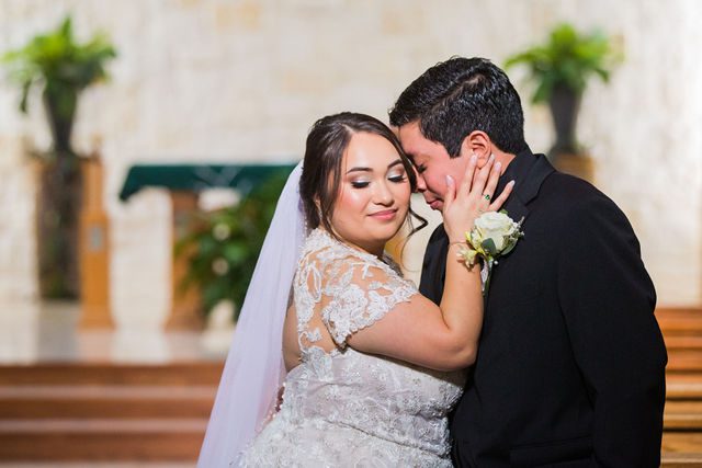 Chloe's San Antonio wedding couple snuggle at St. Dominic's Catholic