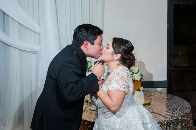 Chloe's San Antonio wedding reception at Las Fuentes cake cutting kiss