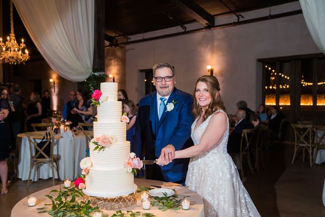 Deborah's Lost Mission wedding bride and groom reception cake cutting