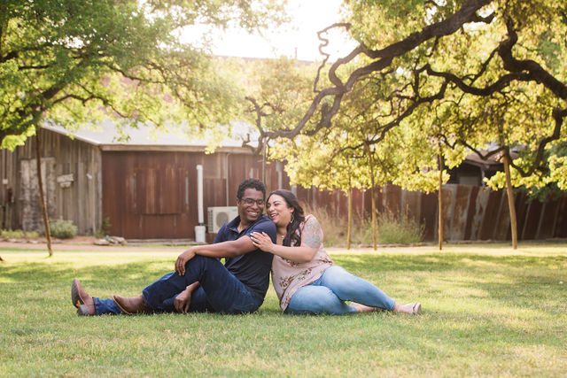 Elexes engagement portrait in Gruene laughing in the grass