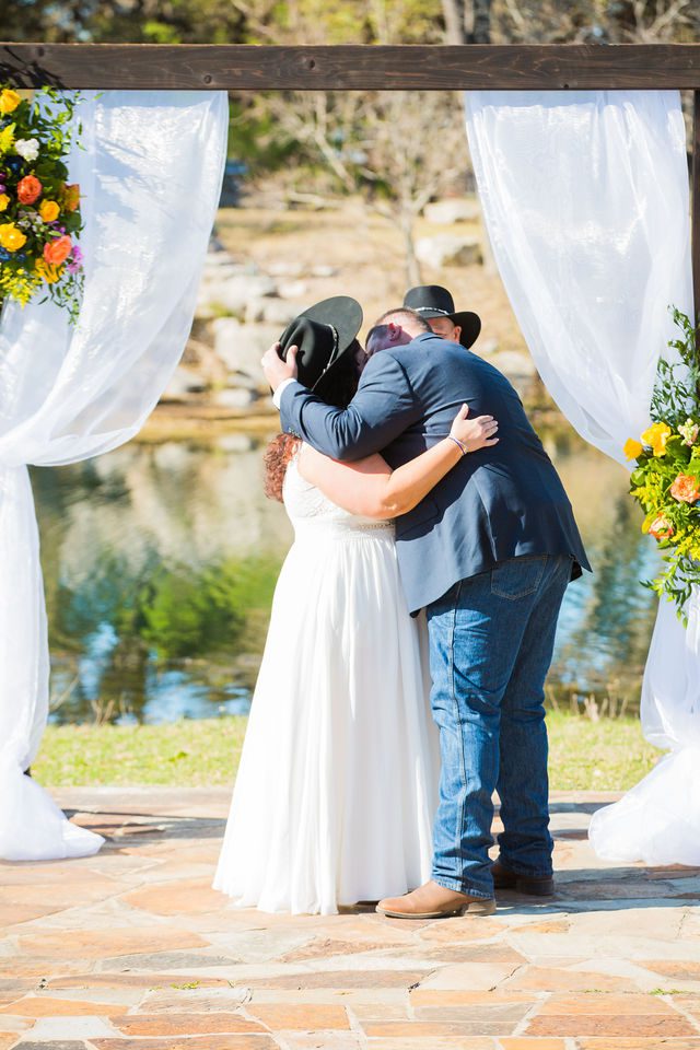 Liz's wedding at Enchanted Springs Ranch ceremony kiss