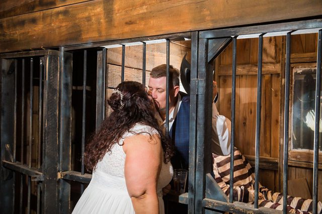 Liz's wedding at Enchanted Springs Ranch jail kiss portrait
