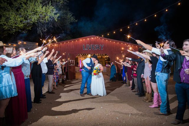 Liz's wedding reception at Enchanted Springs Ranch sparkler exit kiss