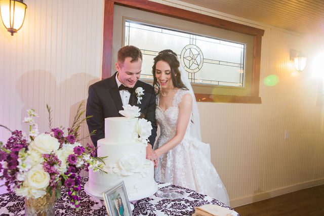 Graysen wedding ceremony in Comfort reception cake cutting